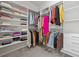 A well-organized walk-in closet with ample shelving, hanging rods, and storage space at 1998 Lakeview Bend Way, Buford, GA 30519