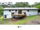 Backyard of home with a new wooden deck and white brick exterior at 2786 Knollview Dr, Decatur, GA 30034