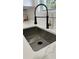 Stylish kitchen sink featuring a modern black and gold faucet and stainless steel basin at 2786 Knollview Dr, Decatur, GA 30034