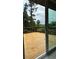 Outdoor deck with wooden floor and iron railing, and view of green trees at 2786 Knollview Dr, Decatur, GA 30034