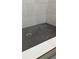 Tile shower floor with black penny tile and white marble-style wall tiles at 2786 Knollview Dr, Decatur, GA 30034