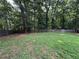 A fenced in yard with many trees and bushes at 296 Hayes Trce, Hiram, GA 30141