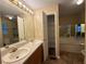 Bathroom featuring double sinks, a soaking tub, and storage shelves at 296 Hayes Trce, Hiram, GA 30141