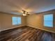 Comfortable bedroom with ample light, fan, and dark wood flooring at 296 Hayes Trce, Hiram, GA 30141