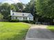 Attractive home with a long driveway, lush lawn, and mature trees, creating a private setting at 296 Hayes Trce, Hiram, GA 30141
