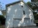 Two-car garage featuring a white vinyl exterior and an upper-level window, enhancing the home's functionality at 296 Hayes Trce, Hiram, GA 30141