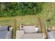 Aerial view shows fully fenced backyard with patio, deck, and mature trees bordering the property at 406 Fernstone Dr, Canton, GA 30114