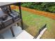 View of spacious fenced backyard, with covered deck area, patio, and steps to the lawn at 406 Fernstone Dr, Canton, GA 30114