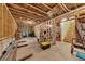 Unfinished basement featuring exposed beams, storage, and staircase at 406 Fernstone Dr, Canton, GA 30114