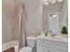 Bathroom with a shower-tub combo and a neutral-toned tile surround at 406 Fernstone Dr, Canton, GA 30114