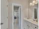 Bright bathroom featuring a white vanity, and a view into an adjacent bedroom at 406 Fernstone Dr, Canton, GA 30114