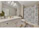 Bright bathroom with white vanity and patterned shower curtain at 406 Fernstone Dr, Canton, GA 30114