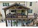 An inviting outdoor covered deck, complete with comfortable seating, string lights, and a relaxing atmosphere at 406 Fernstone Dr, Canton, GA 30114