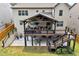 A spacious covered deck with comfortable seating, ceiling fans, and a staircase leading to the yard at 406 Fernstone Dr, Canton, GA 30114