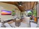 Expansive covered deck boasts outdoor kitchen, dining, and comfortable seating with ceiling fans at 406 Fernstone Dr, Canton, GA 30114