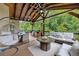Large covered deck features ceiling fans, seating, dining, and an outdoor kitchen at 406 Fernstone Dr, Canton, GA 30114