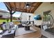 Cozy covered deck with wood ceiling, ceiling fan, TV, seating and egg chair at 406 Fernstone Dr, Canton, GA 30114