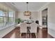 Formal dining room with hardwood floors, natural light, and stylish chandelier at 406 Fernstone Dr, Canton, GA 30114