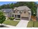Two-story brick home with a well-manicured front yard, two-car garage, and sidewalk at 406 Fernstone Dr, Canton, GA 30114
