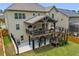 Exterior of home with large, covered deck, stairs to yard, and manicured lawn at 406 Fernstone Dr, Canton, GA 30114