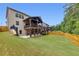 Exterior rear view with upper level covered deck and lower-level covered patio and backyard at 406 Fernstone Dr, Canton, GA 30114