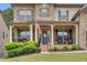 Inviting covered front porch with rocking chairs, American flag, and attractive landscaping at 406 Fernstone Dr, Canton, GA 30114
