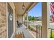 Cozy covered front porch with rocking chair, welcome sign, and a view of the neighborhood at 406 Fernstone Dr, Canton, GA 30114
