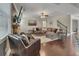 Spacious living room with a large sectional, cozy fireplace, and staircase, perfect for relaxation and entertaining at 406 Fernstone Dr, Canton, GA 30114
