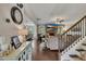 Open-concept living room with hardwood floors, cozy fireplace, and staircase, perfect for relaxation and entertaining at 406 Fernstone Dr, Canton, GA 30114