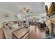 Open-concept living room flows to a kitchen, featuring hardwood floors, comfortable seating, and a cozy fireplace at 406 Fernstone Dr, Canton, GA 30114