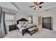 Primary bedroom featuring a tray ceiling, sitting area, and a king bed at 406 Fernstone Dr, Canton, GA 30114