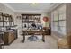 Inviting home office with decorative shelving, warm lighting, and comfortable furnishings for an inspiring workspace at 406 Fernstone Dr, Canton, GA 30114