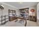 Inviting home office with decorative shelving, warm lighting, and comfortable furnishings for an inspiring workspace at 406 Fernstone Dr, Canton, GA 30114