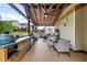 Covered outdoor kitchen and dining area with built-in grill and ample seating at 406 Fernstone Dr, Canton, GA 30114