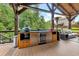 Outdoor kitchen featuring a built-in grill, beverage fridge, and stylish cabinetry at 406 Fernstone Dr, Canton, GA 30114