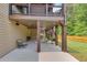 Covered patio with seating, stairs to upper deck, and fenced-in backyard at 406 Fernstone Dr, Canton, GA 30114