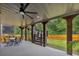 Spacious covered patio with ceiling fans, stairs, and outdoor seating area at 406 Fernstone Dr, Canton, GA 30114