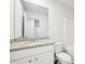 Bright bathroom featuring a granite countertop vanity and framed mirror at 4437 Ben Hill Rd, Atlanta, GA 30349