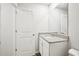Well-lit bathroom with a granite countertop vanity and white cabinets at 4437 Ben Hill Rd, Atlanta, GA 30349