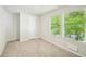 Bright bedroom with plush carpeting and tree views from double windows at 4437 Ben Hill Rd, Atlanta, GA 30349