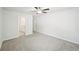 Spacious carpeted bedroom with a ceiling fan and doorway leading to the bathroom at 4437 Ben Hill Rd, Atlanta, GA 30349