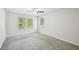 Spacious carpeted bedroom with tree views from double windows and ceiling fan at 4437 Ben Hill Rd, Atlanta, GA 30349