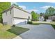 Home's exterior features a garage, driveway, and partial green lawn at 4437 Ben Hill Rd, Atlanta, GA 30349