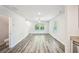 Open-concept living area with wood-look flooring and abundant natural light at 4437 Ben Hill Rd, Atlanta, GA 30349