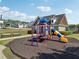 Community playground with play equipment and seating, surrounded by shrubs and green space at 4437 Ben Hill Rd, Atlanta, GA 30349