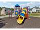 Community playground equipment and play area next to well-kept neighborhood street and homes at 4437 Ben Hill Rd, Atlanta, GA 30349