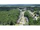 Aerial view of the neighborhood showcasing the home's location surrounded by lush greenery and mature trees at 1703 Rifle Sw Rdg, Marietta, GA 30064