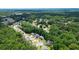 An aerial view showcases a neighborhood surrounded by abundant trees and landscaping at 1703 Rifle Sw Rdg, Marietta, GA 30064