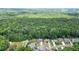 An aerial shot displays the home's placement amidst lush woodlands at 1703 Rifle Sw Rdg, Marietta, GA 30064