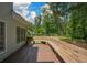 An expansive wooden back deck is perfect for entertaining or relaxing, with a view of the fenced backyard and surrounding trees at 1703 Rifle Sw Rdg, Marietta, GA 30064